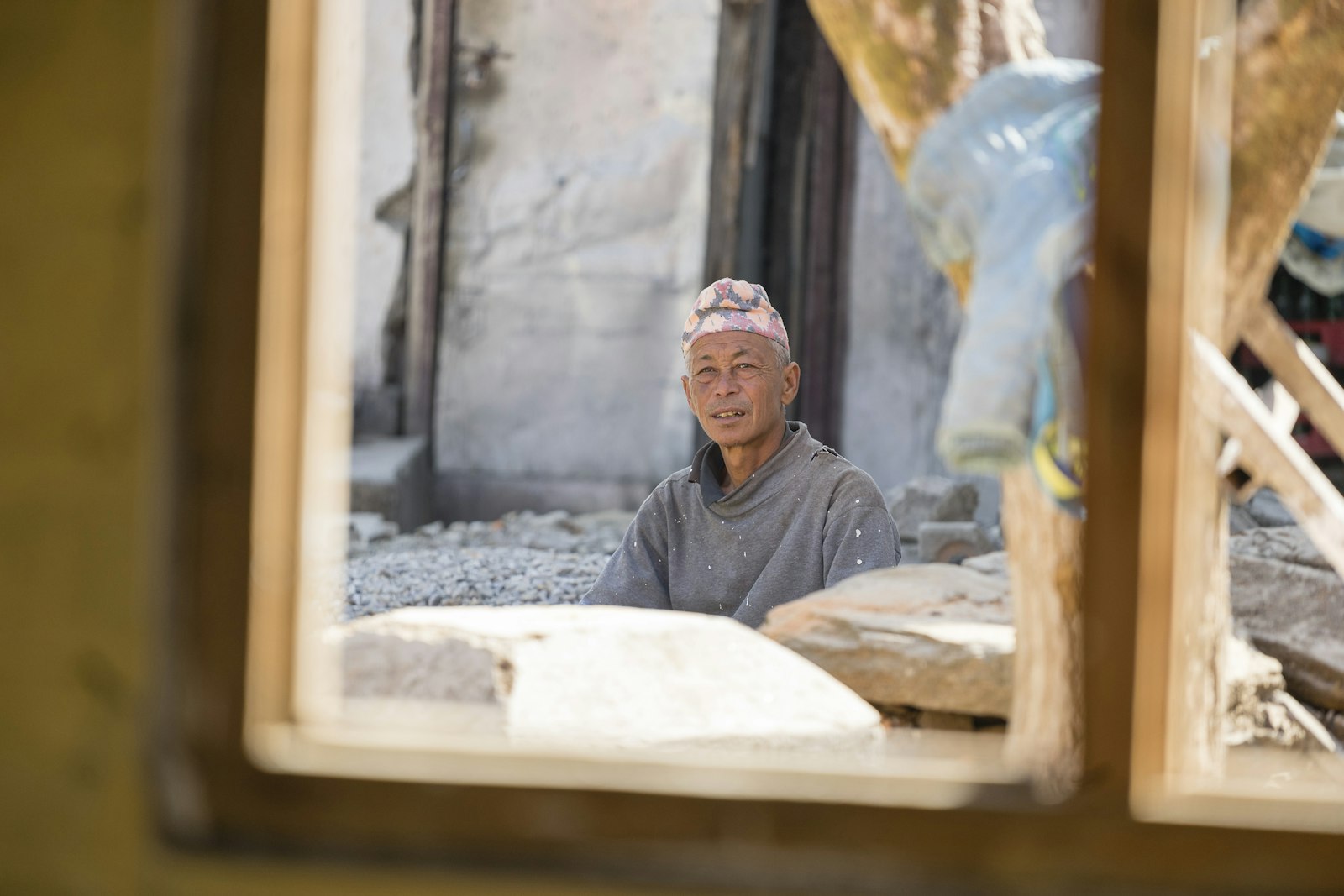 Portrait of a carpenter with wall framing behind